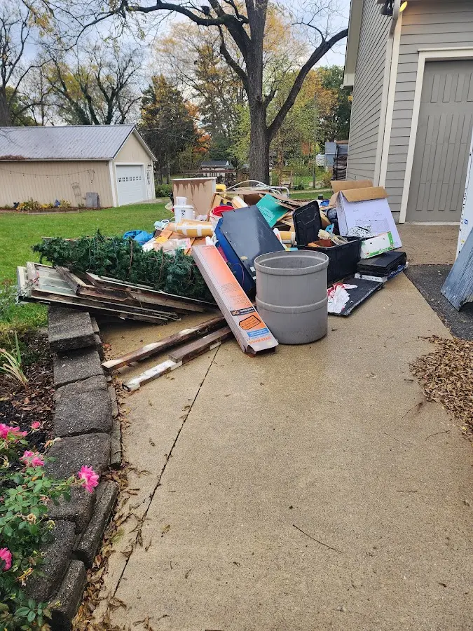 Dumpster being loaded with debris for 12 Yard Dumpster Rental in Ligonier